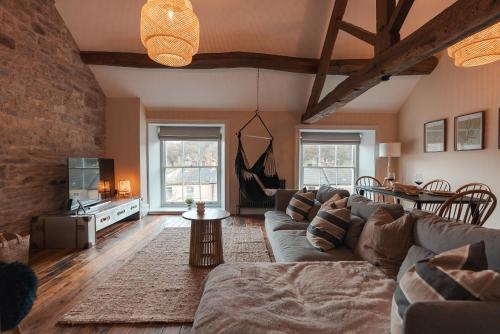 a living room with a couch and a table at The Jodrell Luxury Suites in Whaley Bridge