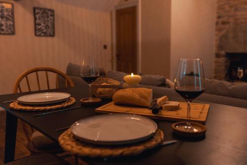a table with plates and wine glasses and a candle at The Jodrell Luxury Suites in Whaley Bridge