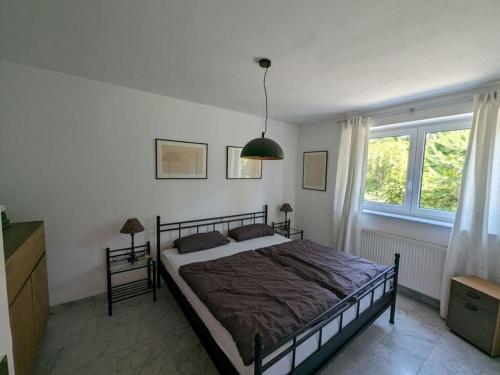 a bedroom with a bed and a large window at Majestic apartment in Werder in Werder