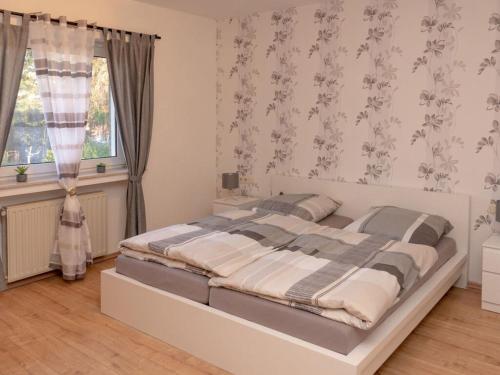 a bedroom with a large white bed in front of a window at Quaint apartment in Soest in Soest