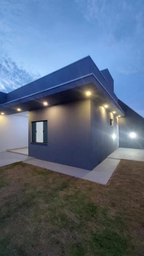 a large house with lights on the side of it at Casa para 04 Pessoas in Lucas do Rio Verde