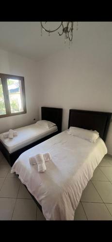 a bedroom with two beds with towels on them at City view in Elbasan