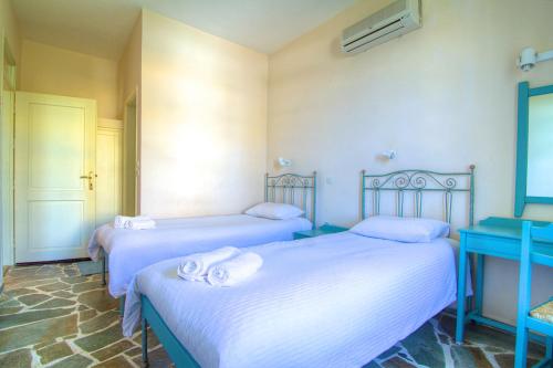 a room with two beds with towels on them at Sea View Villas in Episkopí- Rethimno