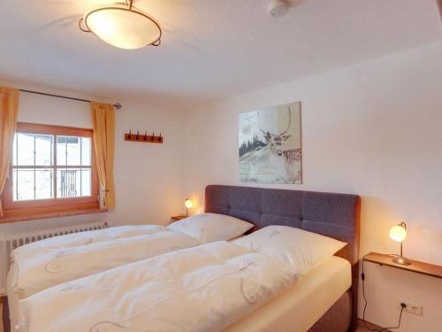 a bedroom with two beds and a window and two lamps at Lovely apartment in Berchtesgaden in Berchtesgaden