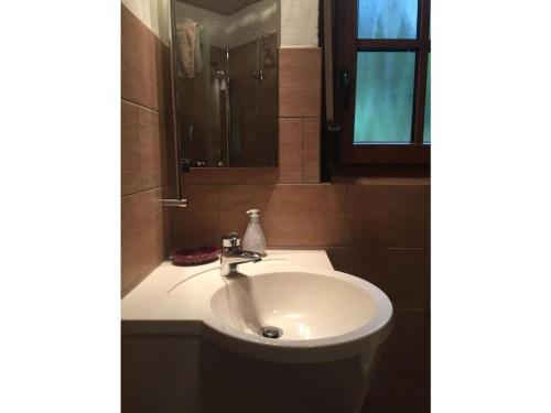 a white sink in a bathroom with a mirror at Appealing apartment in Lenzkirch in Lenzkirch