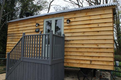 a tiny house with a porch and a deck at The Apple Inn in Lucker