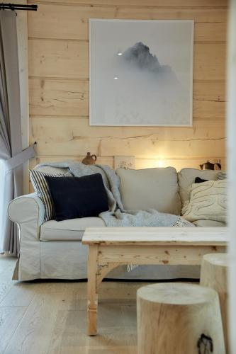 a living room with a white couch and a table at Chochołóvka in Chochołów
