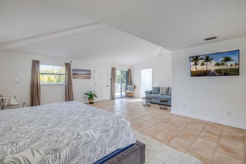 a bedroom with a bed and a living room at Approx 40 steps to beach entrance of Anna Maria beach in Anna Maria
