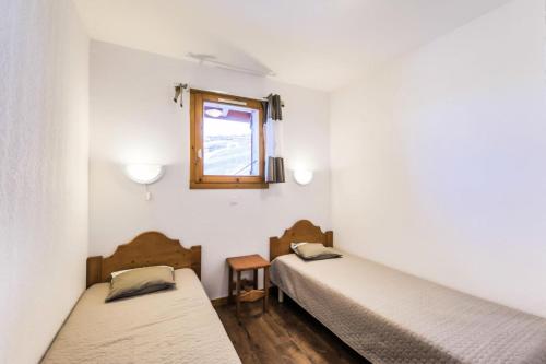 two beds in a room with a window at Résidence Les Valmonts - maeva Home - Appartement 2 Pièces 4 Personnes - Sélection MAE-1036 in Saint-Martin-de-Belleville