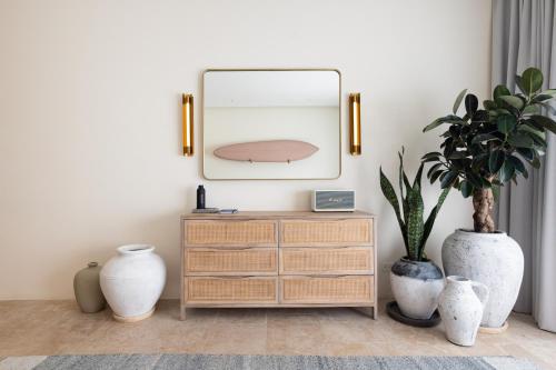 a living room with a dresser and a mirror at Silvestre Nosara Hotel & Residences in Nosara