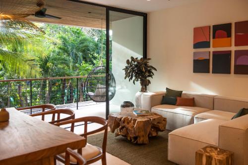 a living room with a couch and a table at Silvestre Nosara Hotel & Residences in Nosara