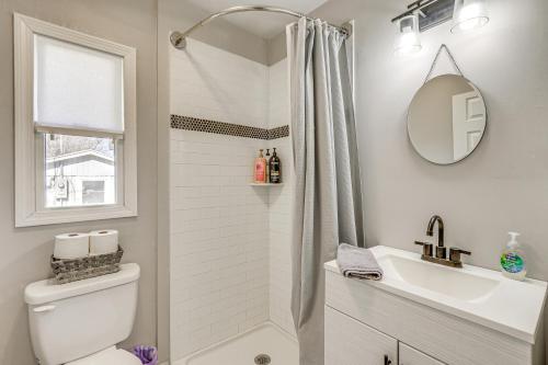 a bathroom with a toilet and a sink and a mirror at Charming Deep River Vacation Rental on Star Lake! in Deep River