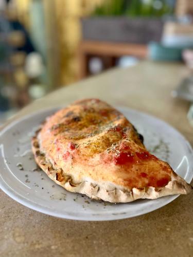 a piece of food on a plate on a table at Фетрбуш in Nadvirna