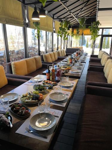 a long table with plates of food on it at Фетрбуш in Nadvirna