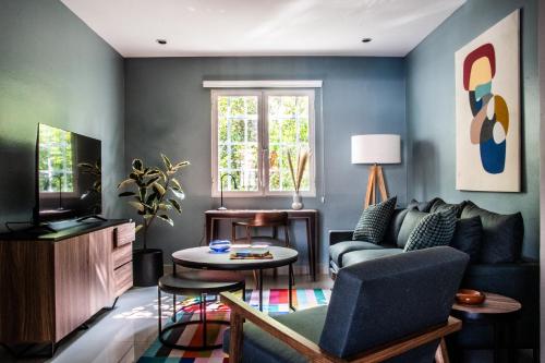 a living room with a couch and a tv at HUATUSCO By Mr W in Mexico City