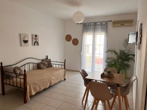 a bedroom with a bed and a table and chairs at Maria Apts in Istro