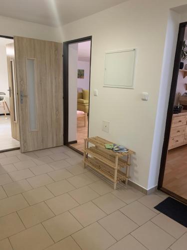 a living room with a door and a wooden table at Penzion Pod pecí in Lenora