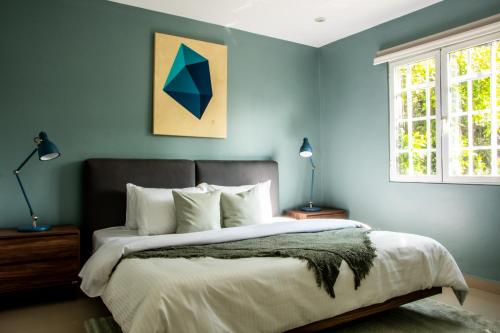 a bedroom with a large bed with blue walls at HUATUSCO By Mr W in Mexico City