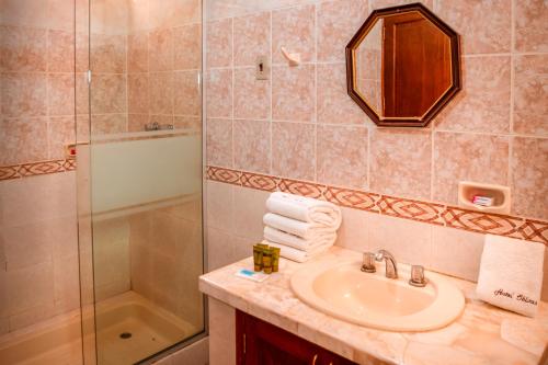 a bathroom with a sink and a shower at Hotel Oblitas in Cochabamba