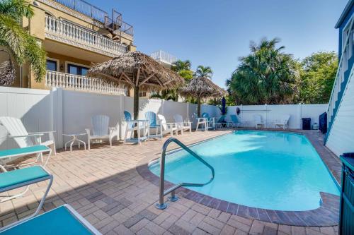 a pool with chairs and tables and umbrellas at Seagrass Flats 2 offers prime location that in Bradenton Beach