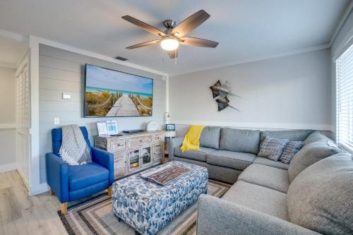 a living room with a couch and a ceiling fan at Seagrass Flats 2 offers prime location that in Bradenton Beach
