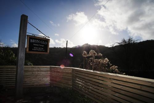 a sign for a fence with the sun in the background at Bryn Glo in Capel-Curig