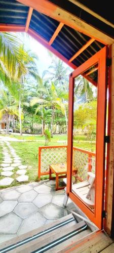 an open door to a porch with a picnic table at Blue Mango Beach Hotel in Guachaca