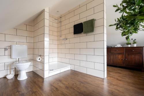 a bathroom with a toilet and a bath tub at Ferienwohnung Kleiner Storch - Seehotel Dümmer in Hüde