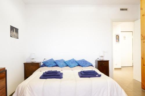 a bedroom with a bed with blue pillows on it at GRANDE TERRAZZA CON VISTA MARE parziale in Francavilla al Mare