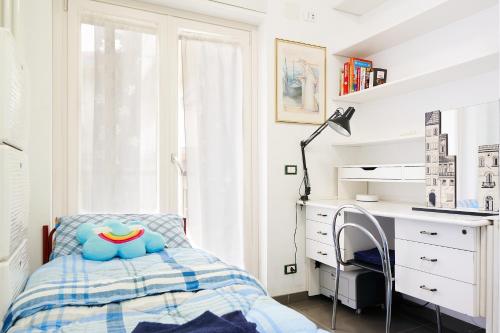 a small bedroom with a bed and a desk at GRANDE TERRAZZA CON VISTA MARE parziale in Francavilla al Mare