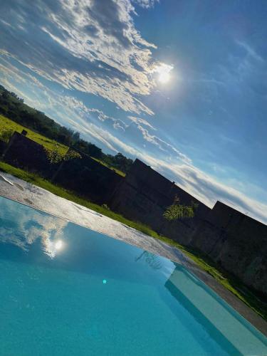 a view of a body of water with the sun at Espaço Mattigor in Caçapava