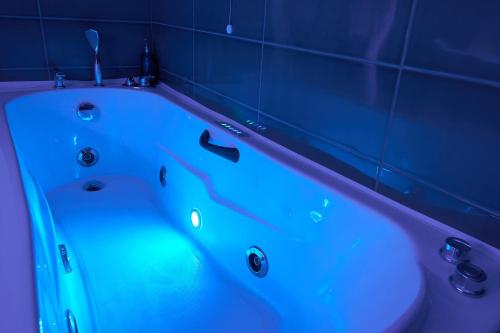 a bath tub with a blue light in a bathroom at GRANDE TERRAZZA CON VISTA MARE parziale in Francavilla al Mare