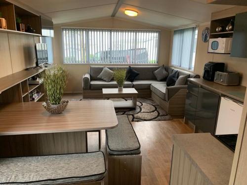 a living room with a couch and a table at Littlesea Haven Rachel's Retreat in Wyke Regis