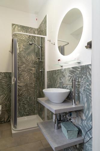 a bathroom with a sink and a shower at THE SUN HOTEL BOUTIQUE NAPOLI in Naples