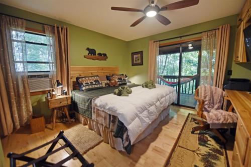 a bedroom with a bed and a ceiling fan at Poplar Ridge Retreat in Blairsville