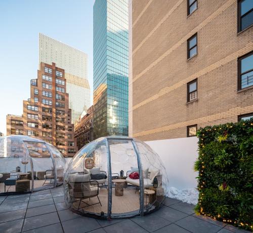 a couple of glass domes on a patio in a city at Little Charlie Hotel in New York