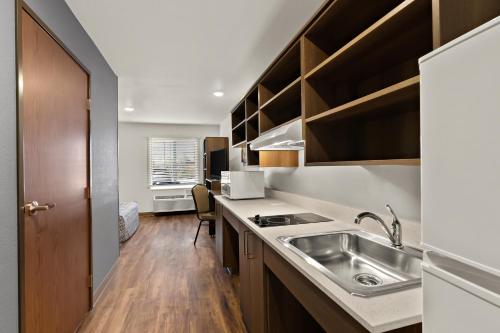 a kitchen with a sink and a counter top at WoodSpring Suites Fort Collins in Fort Collins