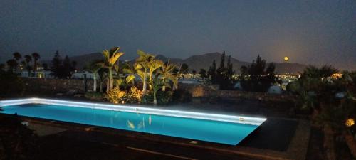 a swimming pool at night with a view at HC LUXURY CELAVELLa in Playa Blanca