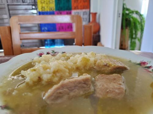 a plate of food with mashed potatoes and gravy at Hostal Casa Del Sol Comitan in Comitán de Domínguez
