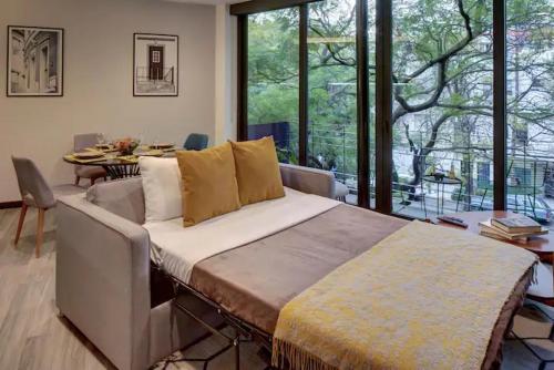 a bedroom with a large bed and a dining room at VERACRUZ by MrW in Mexico City