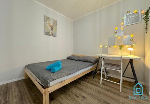 a small bedroom with a bed and a desk at Spacious Room in Gdańsk