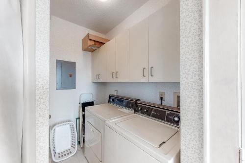 a laundry room with a washer and dryer at Carried Away #16-IC in Avon