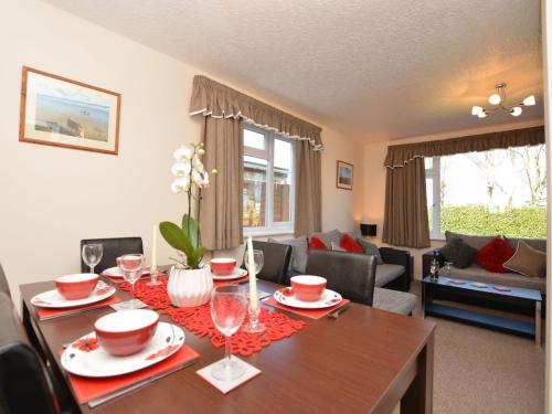 a living room with a wooden table with wine glasses at 3 bed property in Mablethorpe 43220 in Mablethorpe