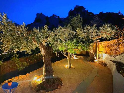 a group of trees in a yard with lights at Aegean Serenity - Sea View Retreat in Archangelos