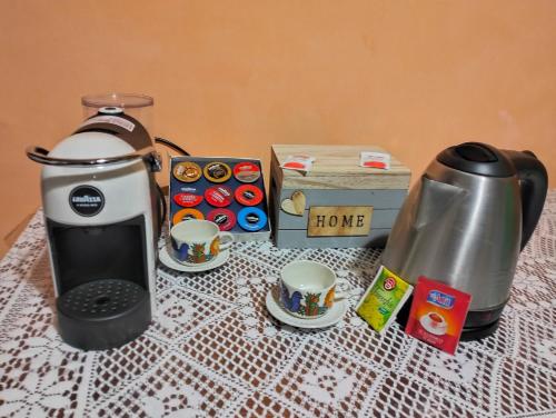 a coffee maker and two cups on a table at La Bomboniera Cascia in Cascia