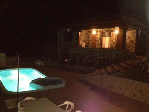 a house with a swimming pool at night at Valdebruna ll y de Gredos in Navaluenga