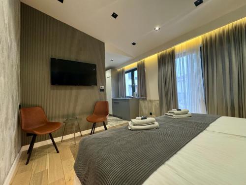 a hotel room with two beds and a flat screen tv at Plaza Apartments in Sarajevo