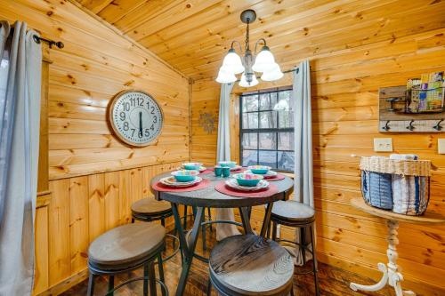 a dining room with a table and stools in a cabin at Broken Bow Abode with Hot Tub Less Than 7 Mi to Lake! in Broken Bow