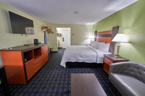 a hotel room with a bed and a couch at The Mariner Resort Cape Cod by The Red Collection in West Yarmouth