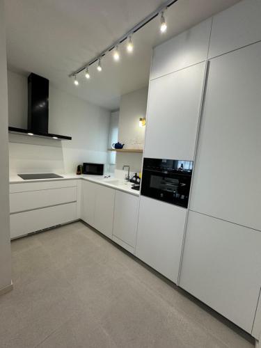 a white kitchen with white cabinets and appliances at DREAM CALLAO in Santa Cruz de Tenerife